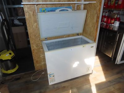 a white chest freezer sitting in a kitchen