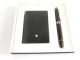 wallet and pen in a box on a white surface with a white background
