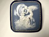 a close up of a blue and white broocher with an angel on it