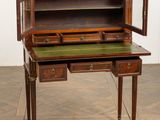 an old desk with a green top and drawers on it
