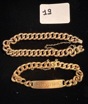 a close up of a gold chain with a tag on it