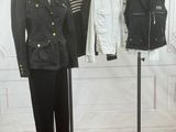 a mannequin display with a variety of jackets on a stand