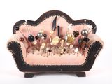 a pink couch with pins on it and a bunch of pins in the back