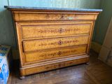 a wooden dresser with a marble top in a room