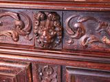 a wooden cabinet with carvings on the top of it