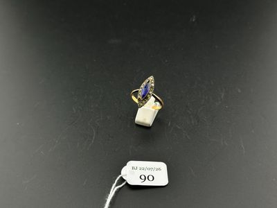 a close up of a ring and a tag on a table