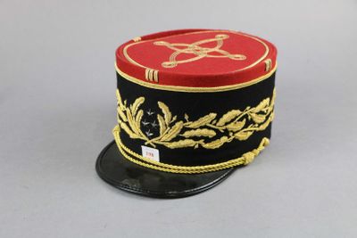a red and black hat with a gold design on it
