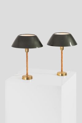 a pair of black lamps sitting on top of a white table