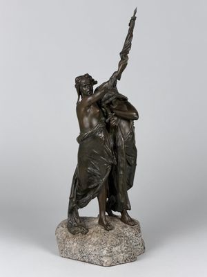 a bronze statue of a woman holding a sword on a rock
