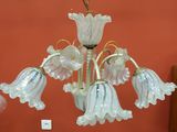 a chandelier made of glass flowers hanging from the ceiling