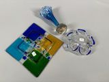 a small glass object on a table next to a small glass object