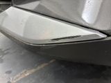 a close up of a car ' s front bumper with scratches on it
