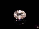 a close up of a white diamond on a black surface