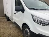 a picture of a white van parked in front of a building