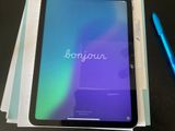 a tablet with the word bonjou on it and a pen next to it
