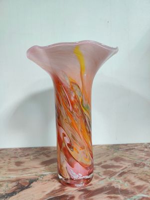 a glass vase sitting on top of a marble table