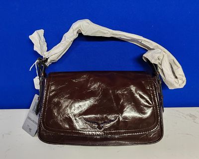 sac à main en cuir marron avec une poignée blanche sur fond bleu