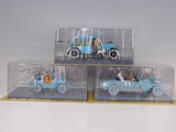 three toy cars in a display case on a table