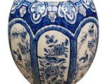 a blue and white vase with a floral design on it