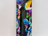 the skateboard has a colorful design on it on a white surface