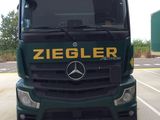 un camion vert garé sur un parking