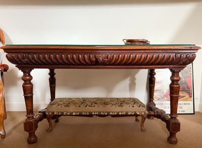 a table with a bench underneath it in a room