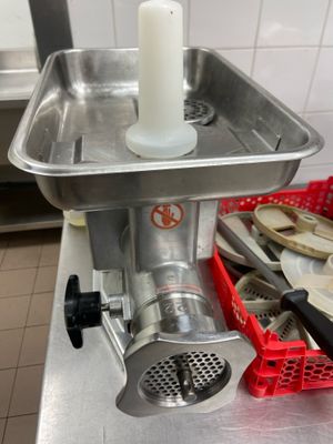 a meat grinder sitting on a counter in a kitchen