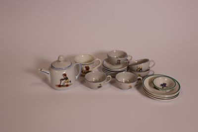 a lot of small cups and saucers sitting on a table