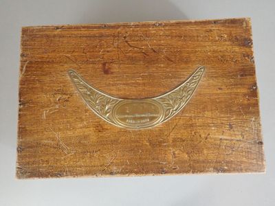 a close up of a wooden box with a metal handle on it