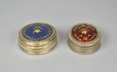two gold and blue tins sitting next to each other