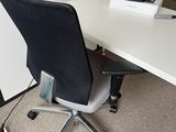 a desk with a chair and a computer monitor on it