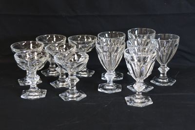 six crystal wine glasses are lined up on a black background