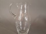 a glass pitcher that is sitting on a table