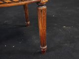 a wooden chair with a black and white checkered seat