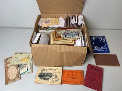 a cardboard box filled with books and papers on a table