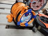 a hose and a reel on a pallet next to other tools