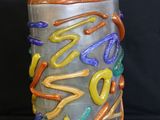 a vase with a colorful design on it on a black background