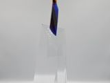 a glass sculpture of a knife on a clear stand