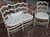 two chairs that are sitting next to each other on a rug