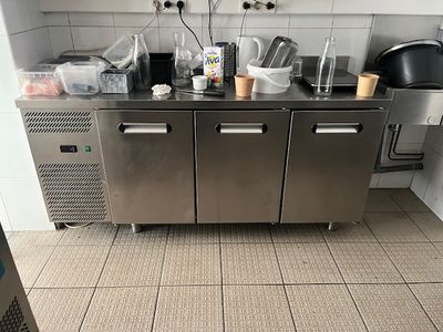 a stainless steel counter with a bunch of dishes on it