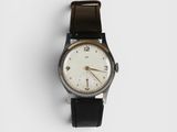 a close up of a watch on a white surface with a white background