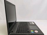 the laptop is sitting on a white surface with a sticker on it