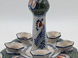 a picture of a table with a vase and cups on it