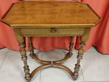an old wooden table with a drawer on top of it