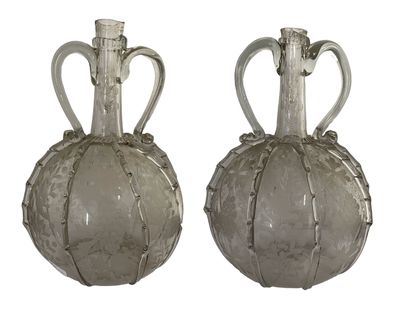 two glass vases that are sitting next to each other
