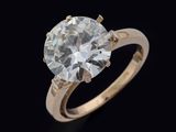 a close up of a diamond ring on a black background