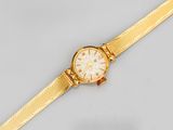 a close up of a gold wrist watch on a white surface