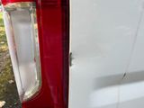 a close up of a red and white van door handle