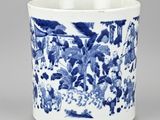 a blue and white cup with a picture of people in a garden