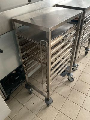 many trays of food sitting on the floor in the kitchen